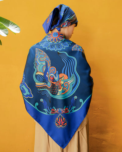 Navy blue Dragon Dreams silk scarf, 44 inch square, draped over the shoulders