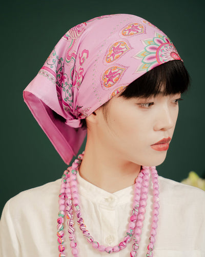 Pink Phoenix Dance silk bandana tied over the hair as a head scarf with a white shirt