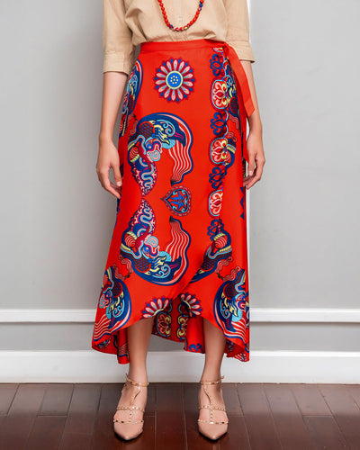 Red Dragon of Grace silk midi wrap skirt with the tie knotted at the hip, worn with a tucked-in beige shirt