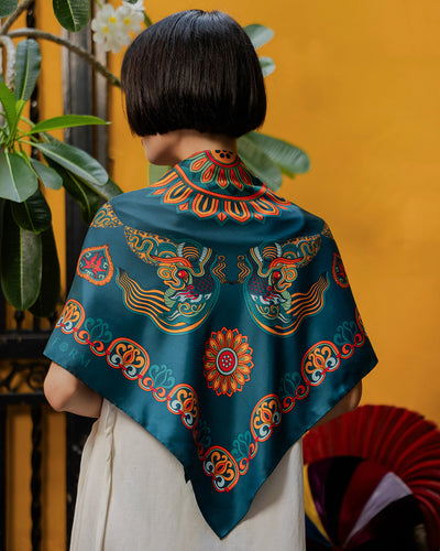Dark green Dragon of Grace silk scarf, 36 inch square, draped over the shoulders, back view