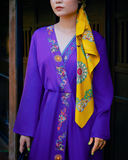 Folk Form silk kimono dress in violet with hand-printed dragon and lotus trim down the front, worn open with a yellow silk scarf