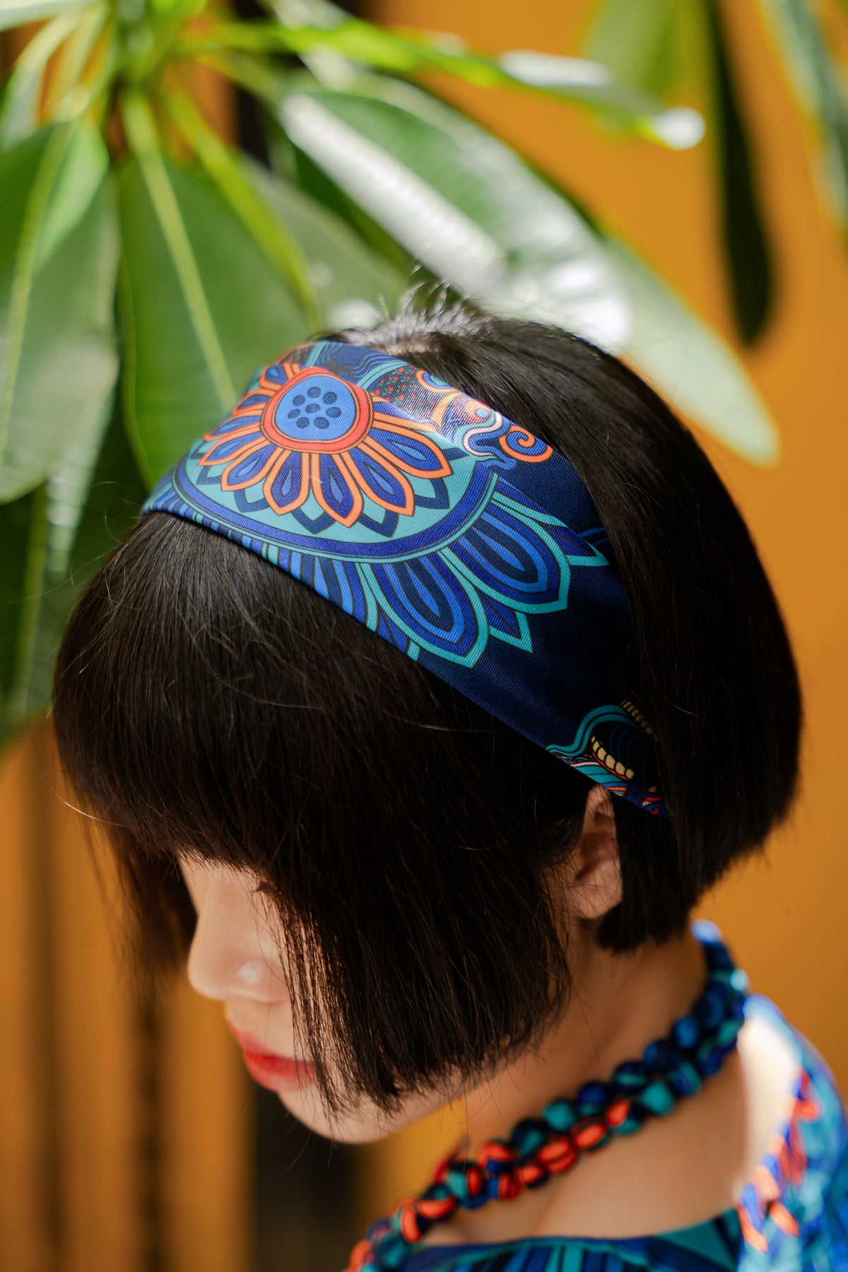 Close view of the navy Dragon of Grace silk scarf as a headband
