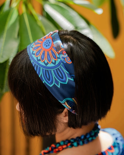 Rear view of the navy Dragon of Grace silk scarf worn as a headband