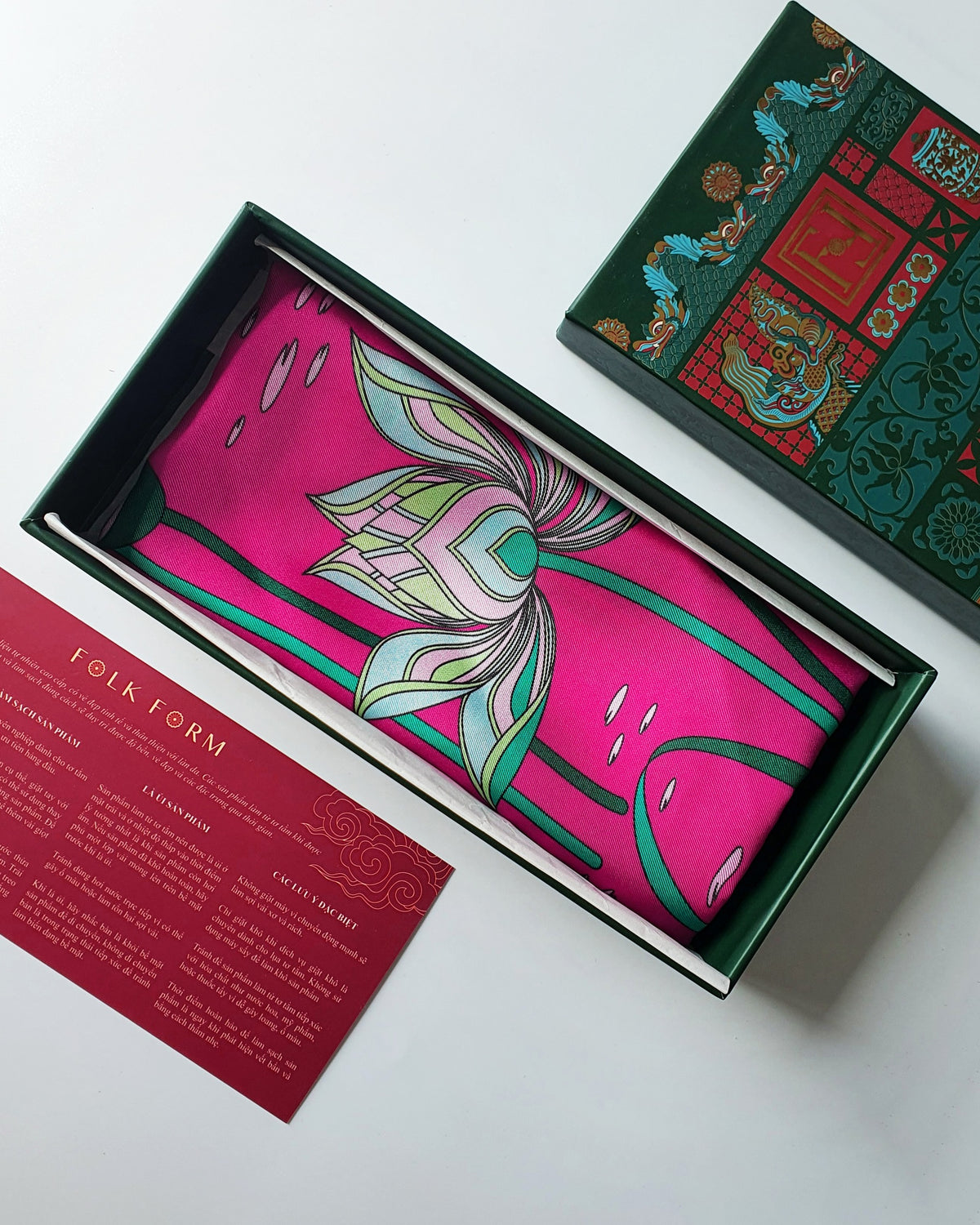 Folk Form heritage green gift box with hot pink Imperial Lotus silk, red care card and printed lid