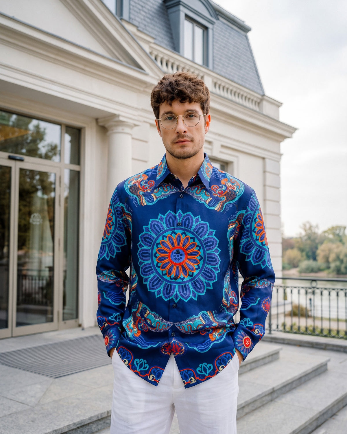 Men's navy Dragon of Grace silk shirt at a hotel entrance