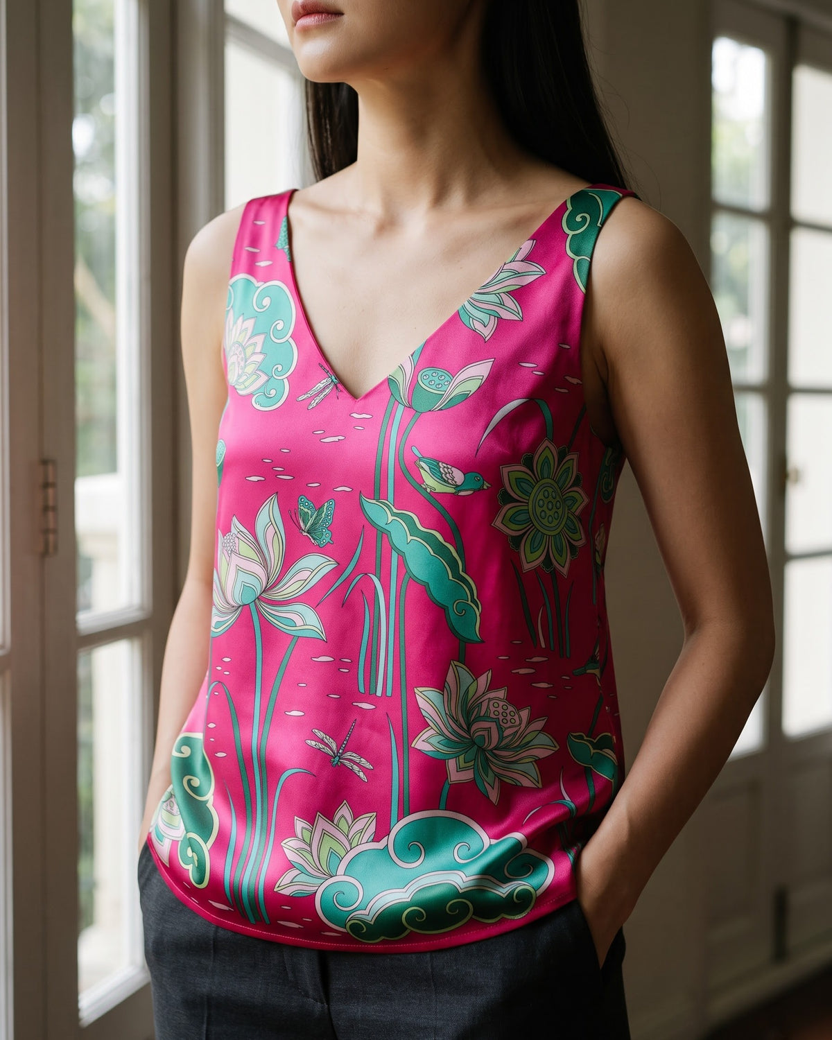Close view of the deep V-neck and hand-printed Imperial Lotus on hot pink mulberry silk satin